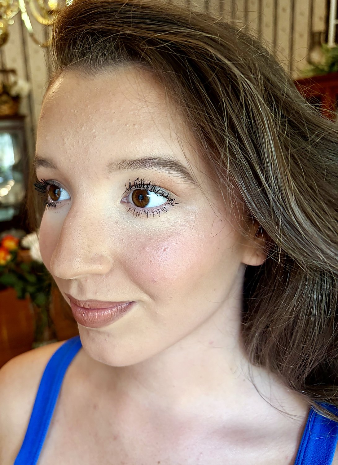 Close-up of natural glow makeup with defined lashes and rosy blush