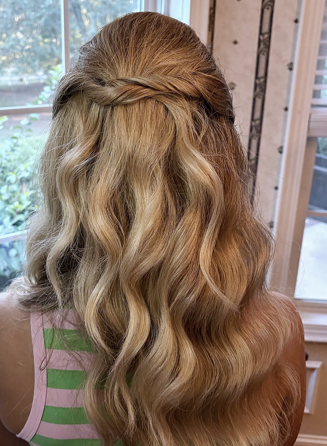 Back view of a half-up twist with long loose waves