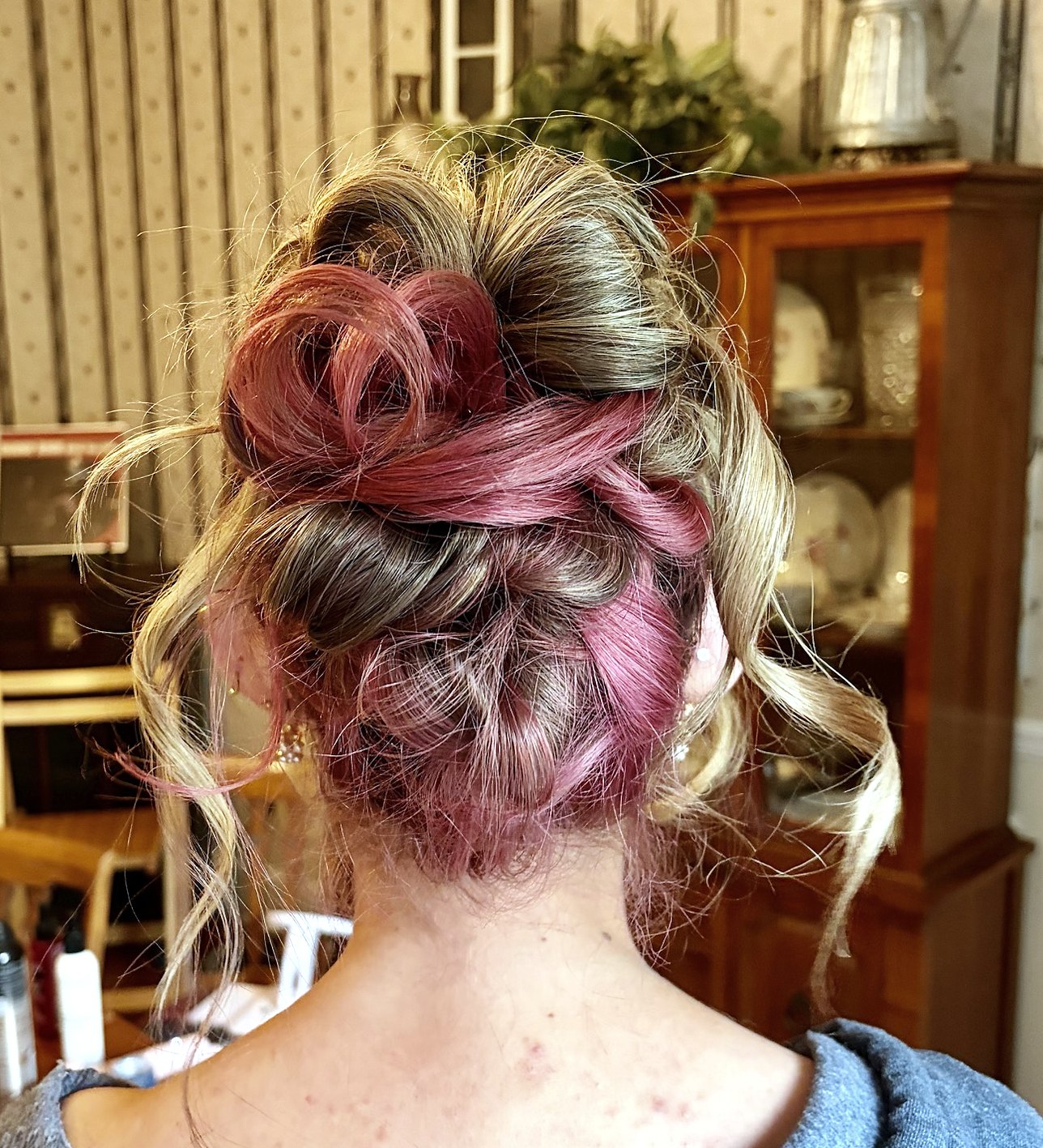 Back view of a loose textured updo with pink and blonde color